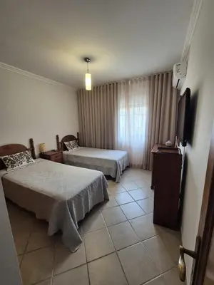 a kitchen with white cabinets and a sink at Apart T2 praia dos bicos in Albufeira