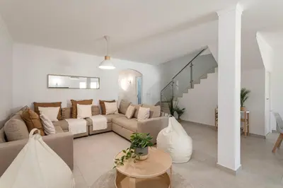 a living room with a couch and a table at The Albufeira Concierge - Casa IÊ in Albufeira