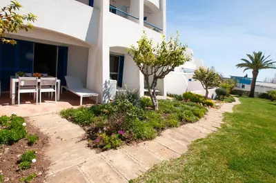 a house with a patio and a table in a yard at Windmill by OCvillas in Albufeira