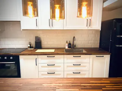 a kitchen with white cabinets and a sink at Vilamoura 2 Bedroom with Pool - Na Casa De Pascal in Vilamoura