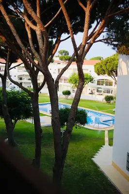 a dining room with a table and chairs and a pool at Vilamoura 2 Bedroom with Pool - Na Casa De Pascal in Vilamoura