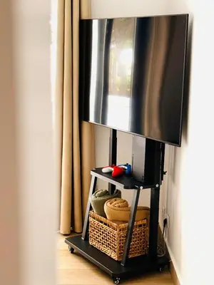 a flat screen tv on a stand with a television at Vilamoura 2 Bedroom with Pool - Na Casa De Pascal in Vilamoura