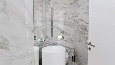 a white bathroom with a shower and a toilet at OneSixOne-Cleverdetails, Luxury villa, Sleeps 8 adults 2 children, Private pool and Jacuzzi in Vilamoura