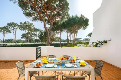 a table with food on it on a patio at Falésia Ocean Villa by The Portuguese Butler in Albufeira