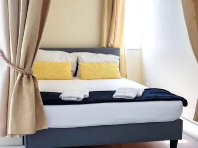 a bedroom with a bed with yellow pillows at Sea View Studio by Stay ici Algarve Holiday Rental in Albufeira