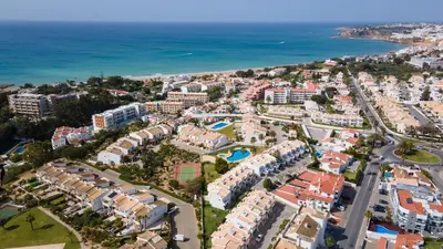 an aerial view of a resort near the ocean at Albufeira 3BR with Pool and AC by the beach by LovelyStay in Albufeira