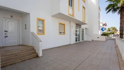 a white building with stairs and a white door at Albufeira 3BR with Pool and AC by the beach by LovelyStay in Albufeira