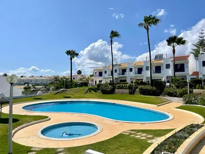 a swimming pool in a resort with palm trees at Albufeira 3BR with Pool and AC by the beach by LovelyStay in Albufeira