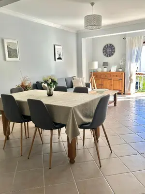 a living room with a table and a couch at Albufeira 3BR with Pool and AC by the beach by LovelyStay in Albufeira