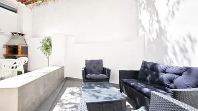 a living room with a couch and a chair at Old Town II Apartment by Stay ici Algarve Holiday Rental in Albufeira
