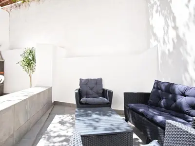 a patio with two chairs and a couch at Old Town II Apartment by Stay ici Algarve Holiday Rental in Albufeira