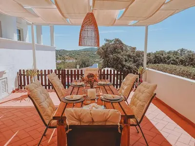 a villa with a swimming pool in front of a house at Green Ville in Faro