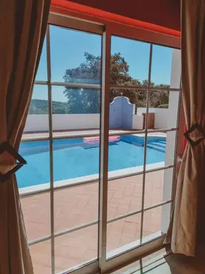 a bedroom with a bed with a checkered floor at Green Ville in Faro