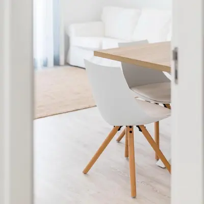 a white chair sitting next to a wooden table at Apartamentos Baltum in Albufeira