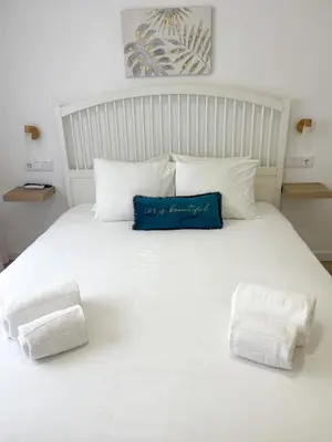 a couch with four pillows on top of it at Solbelo Quarteira Beach in Quarteira