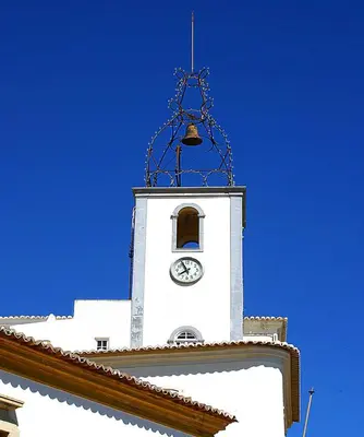 a clock tower with a bell on top of a building at V4, Villa Jardins Branqueira7 near Beach, Albufeira in Albufeira