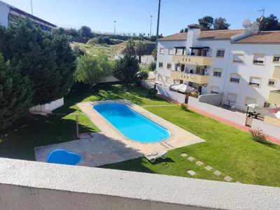 an image of a swimming pool in the yard of a building at Large Duplex Apartment Pool View in Albufeira