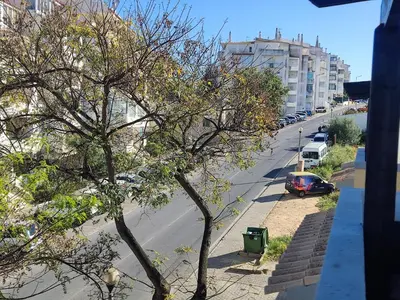 a view of a street with a tree and a car at Large Duplex Apartment Pool View in Albufeira