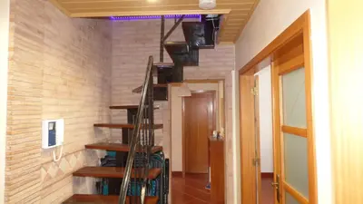 a spiral staircase in a room with a brick wall at Large Duplex Apartment Pool View in Albufeira