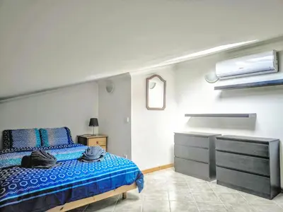 a bedroom with a bed and a tv in it at Large Duplex Apartment Pool View in Albufeira