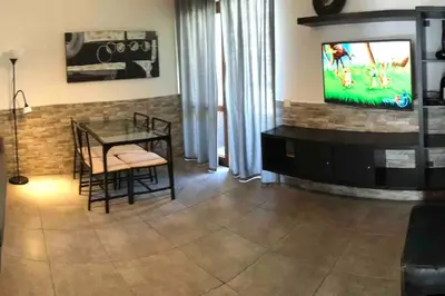 a living room with a dining table and a television at ALEXA APARTMENT T2, Albufeira Center two bedrooms Self check-in in Albufeira