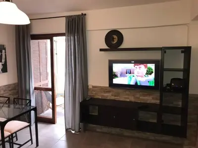 a living room with a flat screen tv on a entertainment center at ALEXA APARTMENT T2, Albufeira Center two bedrooms Self check-in in Albufeira