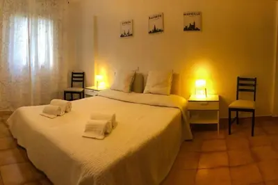 a bedroom with a large white bed with two chairs at ALEXA APARTMENT T2, Albufeira Center two bedrooms Self check-in in Albufeira