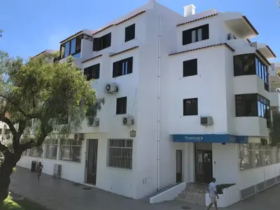 a white building with people walking in front of it at ALEXA APARTMENT T2, Albufeira Center two bedrooms Self check-in in Albufeira