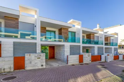 an apartment building with balconies on a street at Casa ALBUFEIRA SUNSET in Albufeira