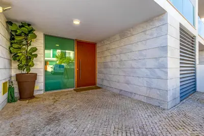 a hallway with a red door and a potted plant at Casa ALBUFEIRA SUNSET in Albufeira