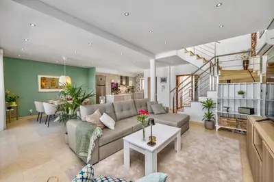 a living room with a couch and a table at Luxury Villa in Serene Location with Pool & Private Garden in Quarteira