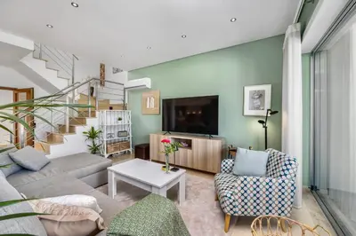 a living room with a couch and a table at Luxury Villa in Serene Location with Pool & Private Garden in Quarteira