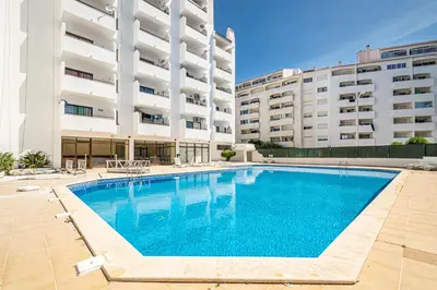 a swimming pool in front of a building at BeGuest Albufeira Visconde Apartment in Albufeira