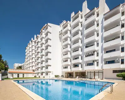 a swimming pool in front of a building at BeGuest Albufeira Visconde Apartment in Albufeira