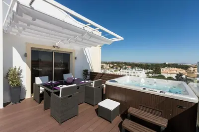 a hot tub on the deck of a house at D_Loft in Albufeira