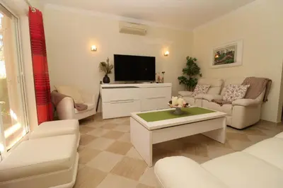 a living room with a couch and a tv at Villa Jóia - 3 Bedroom Villa with Swimming pool in Boliqueime, near Vilamoura, Algarve in Boliqueime