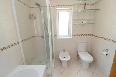 a white bathroom with a toilet and a shower at Villa Jóia - 3 Bedroom Villa with Swimming pool in Boliqueime, near Vilamoura, Algarve in Boliqueime