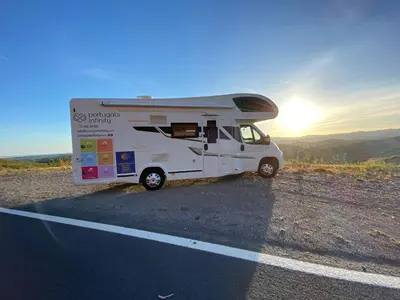 a white caravan parked on the side of a road at Portugals Infinity - AutoCaravana Luxo in Faro