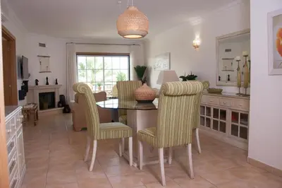 a dining room with a table and chairs at Vila Rosal Margarida Apartment in Albufeira