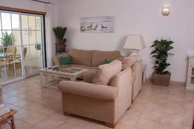 a living room with a couch and a table at Vila Rosal Margarida Apartment in Albufeira