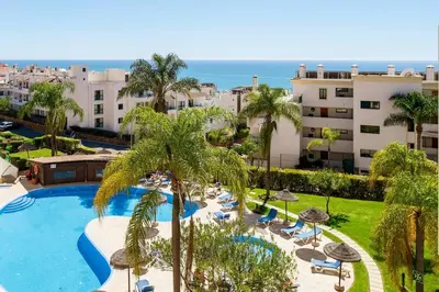 a view of a resort with a pool and palm trees at Albufeira-Sea View/pool Casa Sara Linnea 1bedroom in Albufeira