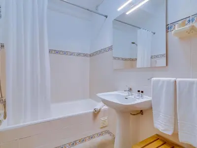 a bathroom with a sink and a shower and a tub at AL - Apartamento Maré Alta in Quarteira