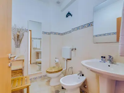 a bathroom with a toilet and a sink at AL - Apartamento Maré Alta in Quarteira