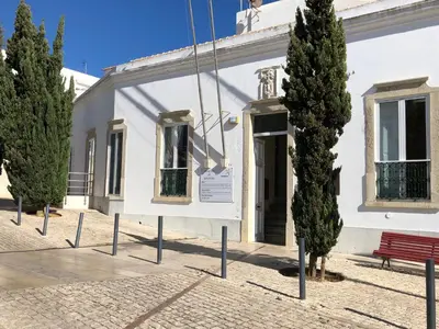 a white building with trees in front of it at Apartamento Flor de Amendoeira in Albufeira