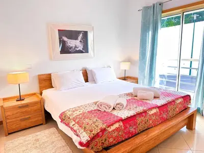 a bedroom with a bed with towels on it at AlbufeiraOrada Garden by Be Cherish in Albufeira