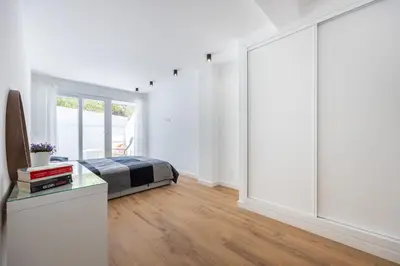 a bedroom with a bed and a large sliding glass door at Alfamar Inês Apartment in Albufeira