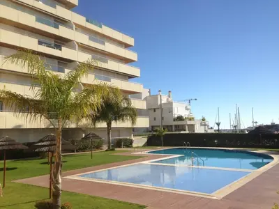a swimming pool in front of a building at Marina Vilamoura Aquamar 116 By Vilamoura Sun in Vilamoura