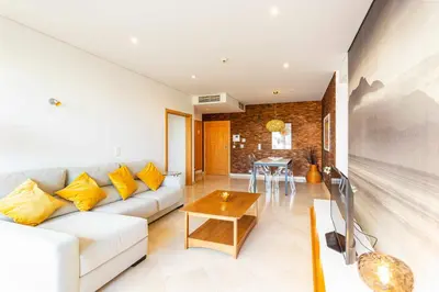 a living room with a couch and a table at Marina Vilamoura - Aquamar 005 By Vilamoura Sun in Quarteira