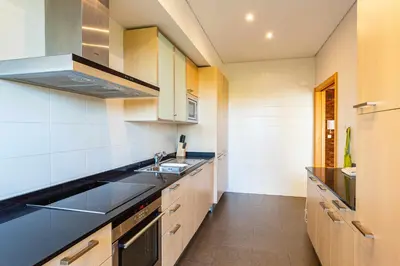 a kitchen with a sink and a stove at Marina Vilamoura - Aquamar 005 By Vilamoura Sun in Quarteira