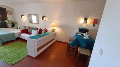 a room with a bed and a couch and a table at ALBUFEIRA TRADICIONAL BEACH APARTMENT in Albufeira